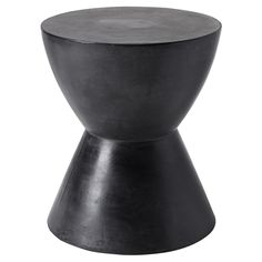 a small black stool sitting on top of a white floor