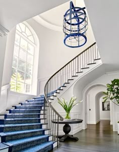 a staircase with blue carpet and white walls