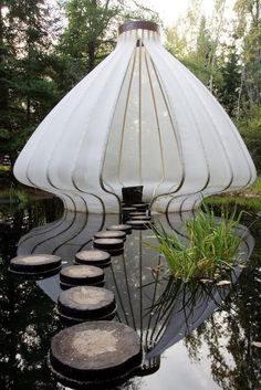 an unusual house is reflected in the water