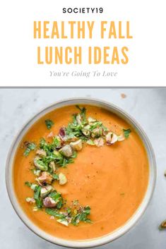 a bowl filled with carrot soup and garnished with chopped vegetables on the side text reads healthy fall lunch ideas you're going to love