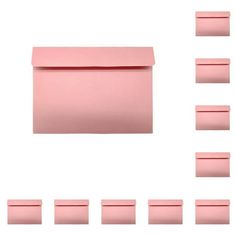 a pink envelope with six different pieces of paper in front of it and eight smaller ones behind it