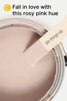 a close up of a paint can with a brush in it that says, fall in love with this rosy pink hue