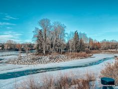 a river running through a snow covered field