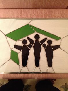 a stained glass sign depicting three people holding hands