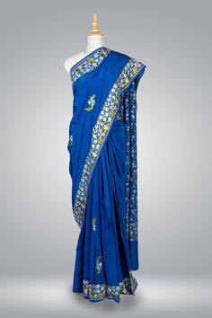 Royal Blue Pure Crepe Kashmiri Saree, Aari Embroidered Saree, Indian Saree Elevate your ethnic wardrobe with this exquisite Royal Blue Kashmiri Saree, meticulously crafted from pure crepe fabric to provide an unparalleled combination of luxury and comfort. The mesmerizing Aari embroidery adorning the saree showcases the rich heritage and skilled artistry that has become synonymous with Kashmiri handcrafts. The enchanting multicolored embroidery, carefully Embroidered into small floral motifs, br Traditional Blue Raw Silk Saree, Transitional Blue Raw Silk Saree, Blue Raw Silk Traditional Wear, Blue Traditional Raw Silk Wear, Traditional Blue Raw Silk Wear, Blue Art Silk Embroidered Fabric For Navratri, Blue Tussar Silk Embroidered Fabric For Festive Occasions, Unstitched Blue Tussar Silk Embroidered Fabric, Blue Tussar Silk Blouse Piece With Resham Embroidery