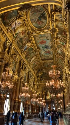 an ornate room with chandeliers and paintings on the ceiling