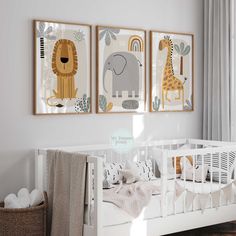 a baby's room with three framed pictures on the wall and a crib