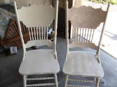 two white chairs sitting next to each other