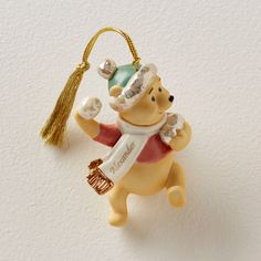 a christmas ornament shaped like a bear with a tassel hanging from it's back