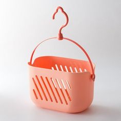 an orange plastic basket hanging from a hook