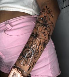 a woman's arm with flowers painted on it