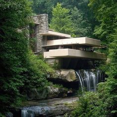 the falling house is surrounded by lush green trees and water flowing from it's sides