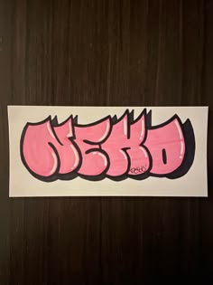 a piece of paper that has some type of writing on it with pink and black letters