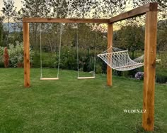 a hammock and swing set in the grass