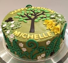 there is a green cake with yellow flowers on the top and black lettering that says, michael