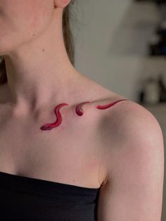 a woman with a red tattoo on her chest