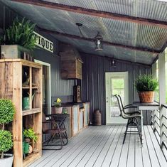 the porch is covered with potted plants and wooden crates on it's sides