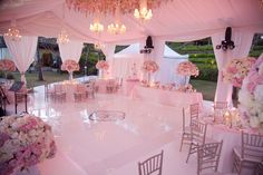 the inside of a wedding tent with tables and chairs