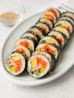 sushi rolls are arranged on a white plate