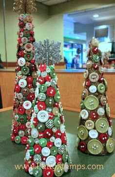 two small christmas trees made out of buttons