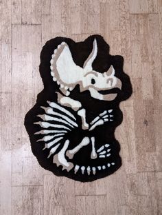 a black and white rug with an animal skeleton on it