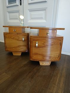 two wooden drawers sitting on top of a hard wood floor next to a white door