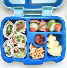 a blue lunch box filled with different types of food