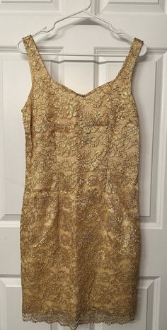 This cocktail dress by Tina Hägen has a tan lining with gold metallic lace overlaid. Size M.  Condition: Excellent Materials: 64% nylon, 36% lurex Measurements:  Pit to pit: 17 inches Total length: 37 inches Waist across: 15.5 inches Strapless Cocktail Dress, Gold Cocktail Dress, My Bday, Gold Cocktail, Saint Paul Mn, Metal Lace, Saint Paul, Lace Overlay, Dress Clothes For Women