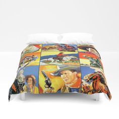 a bed covered in a blanket with pictures of people and animals on the coverlet