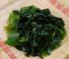 some green vegetables are sitting on a bamboo tray