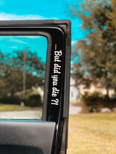 the side view mirror of a truck with writing on it's side door window