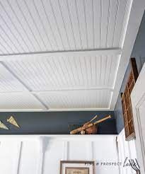 the ceiling is painted blue and has white paneling on it, along with some baseball bats