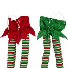 two christmas stockings with bows tied to them, one is green and the other is red