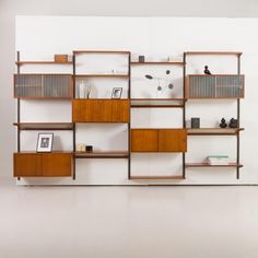 a wooden shelf with books and pictures on it