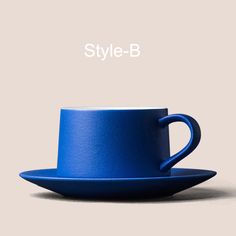 a blue cup and saucer sitting on top of a plate with the word style - b above it