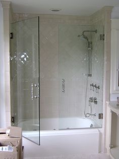 a bathroom with a walk in shower next to a bath tub