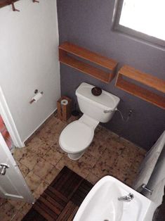 a white toilet sitting next to a bath tub in a bathroom on top of a tiled floor