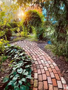 a brick path in the middle of a garden