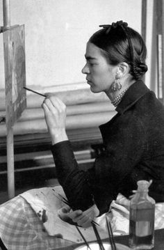 an old photo of a woman painting