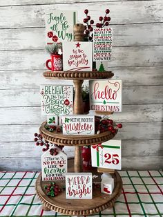 a three tiered christmas tree with cards on it