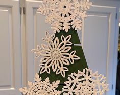 a christmas tree made out of paper snowflakes