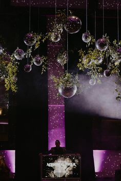 a man standing in front of a tv on top of a stage