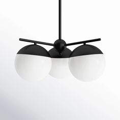 three black and white lights hanging from a ceiling