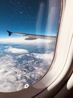 an airplane window looking out at the sky