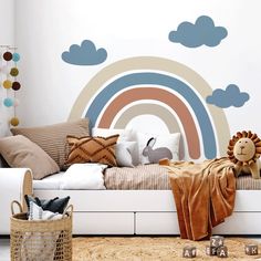 a room with a bed, pillows and a wall mural