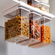 three clear containers filled with food on top of a shelf