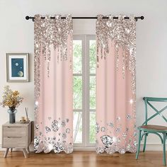 pink curtains with silver sequins on them and a blue chair in front of the window