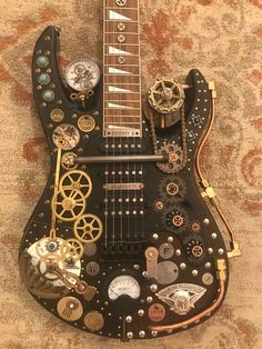 a black guitar with lots of gears on it