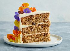 a slice of carrot cake on a plate with flowers