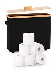 several rolls of toilet paper sitting next to a black box with wooden lid and handles